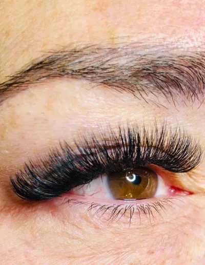 Zoomed photo of an eye showing eyelash extensions example 12 from Aesthetically Speaking in Reno, Nevada.