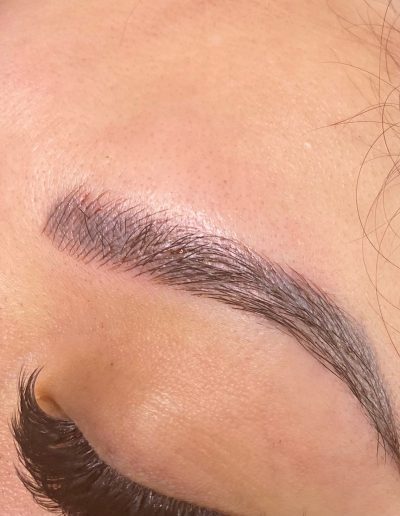 Zoomed in photo showing microbladed eyebrows example 1 from Aesthetically Speaking in Reno, Nevada.